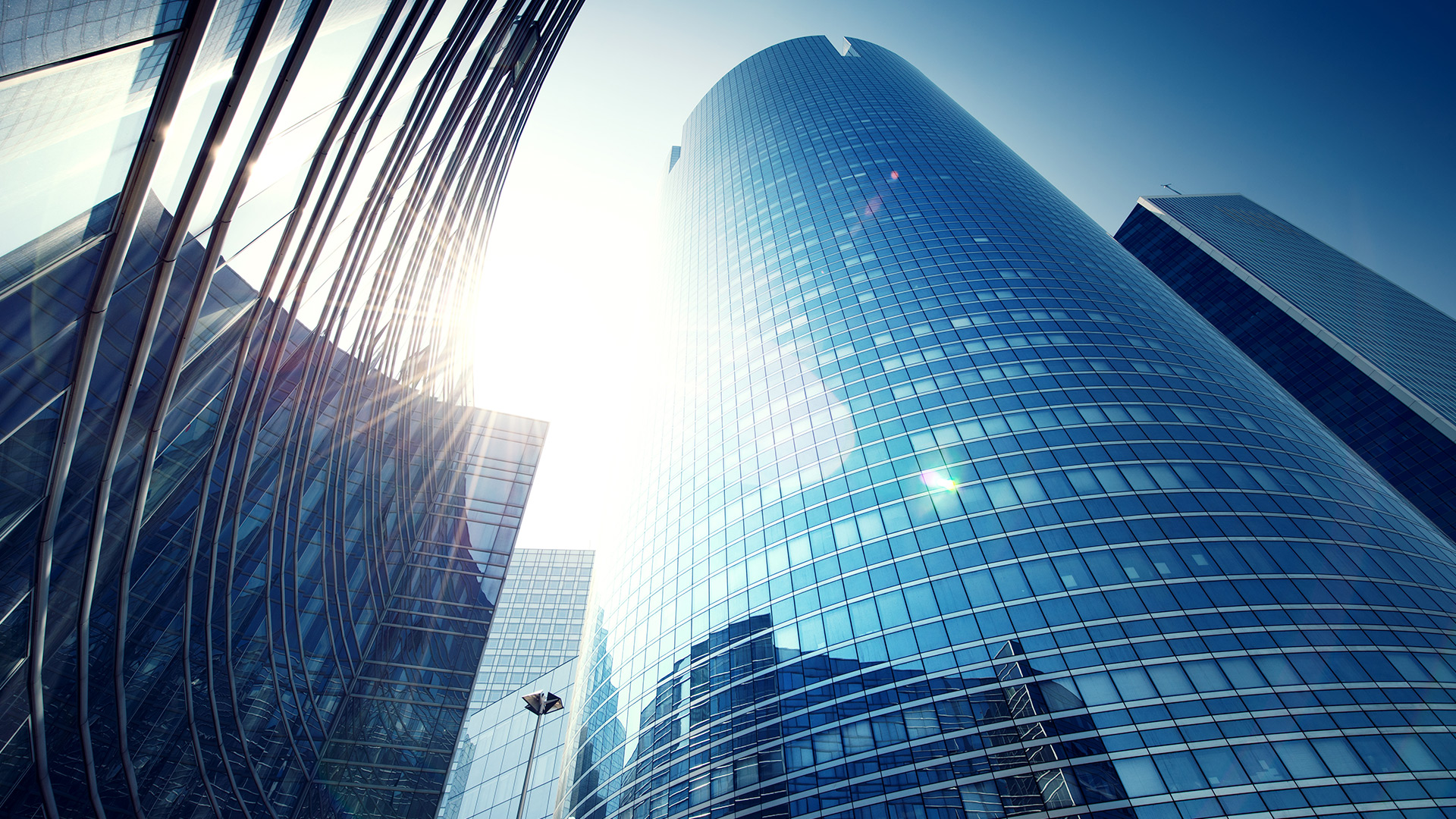 Curved office building reflecting the sun 