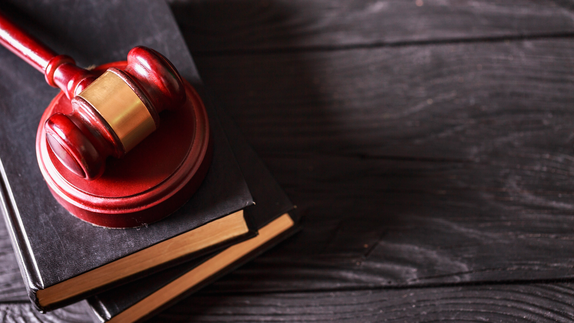 A gavel over books on a table