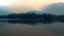 Reflection of trees and mountains on a lake