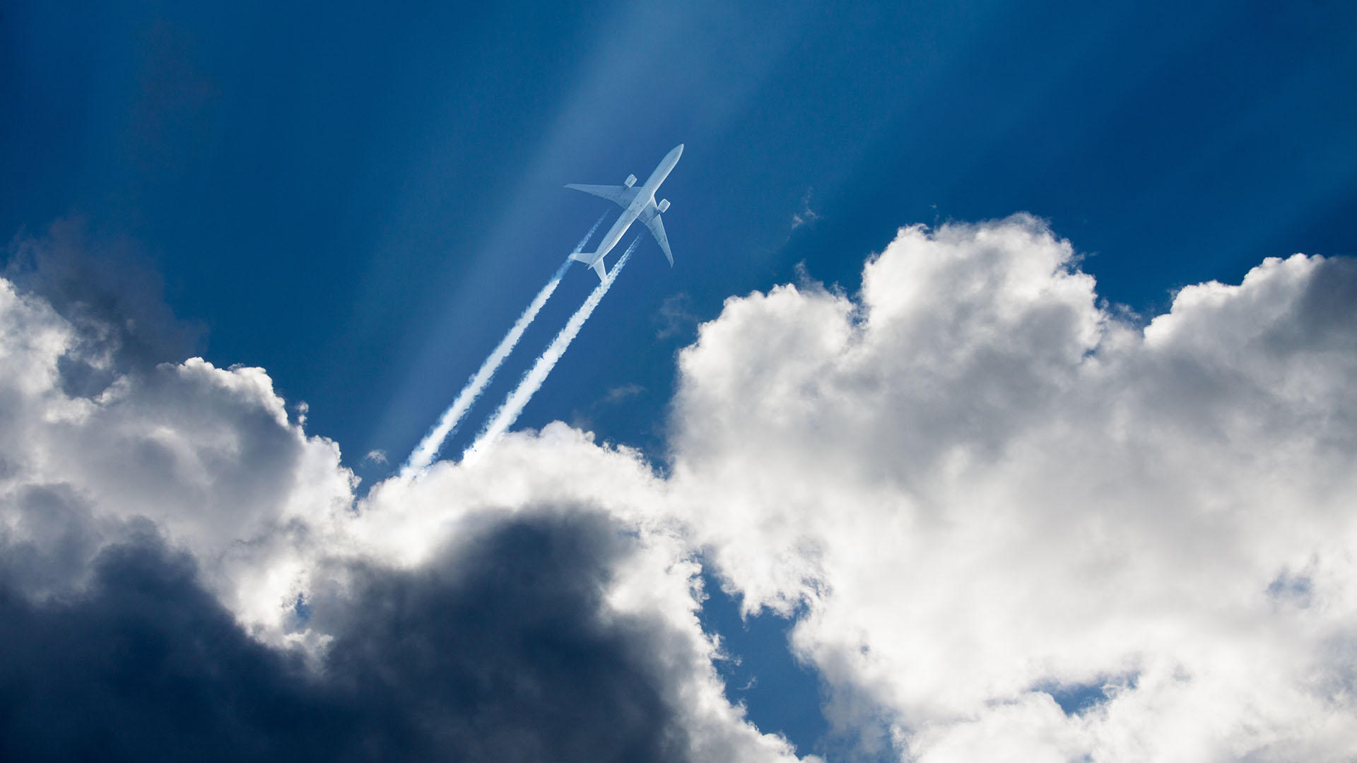 plane appearing behind the clouds