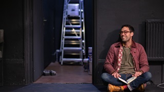 Man sitting beside the doorway