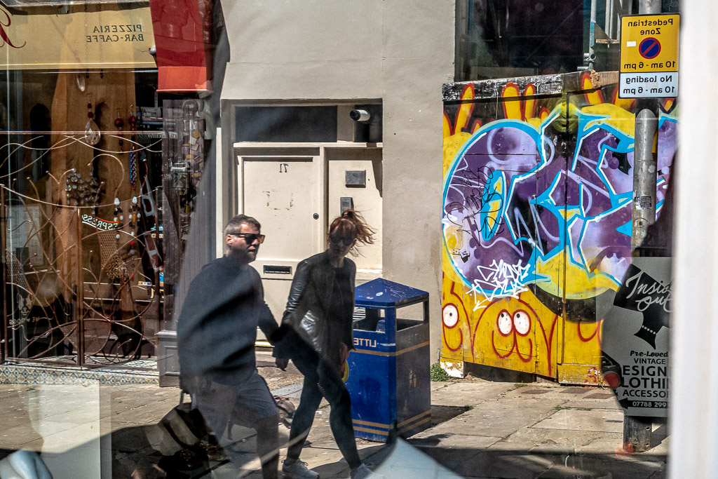 people near blue bin 