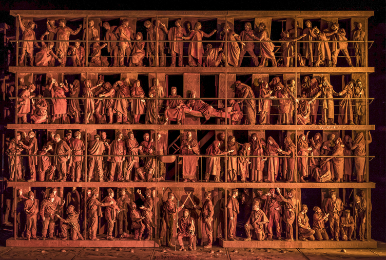 opera scene at ROH (Oedipe) rows of figures as though carved from clay