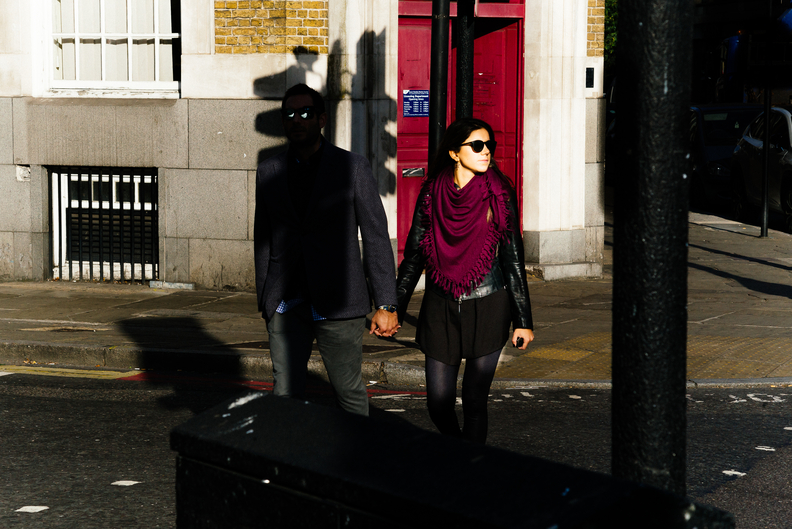 Photo by Heathcote called Zombie Love shows a woman at a street crossing with a man whose eyes are lit with a cold blue light