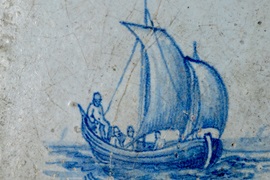 Dutch tile showing a small ship, two sails