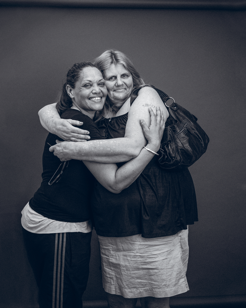 Leearna Foster and Laurel Torrens, visitors to Wayside Chapel in Sydney, in a warm embrace