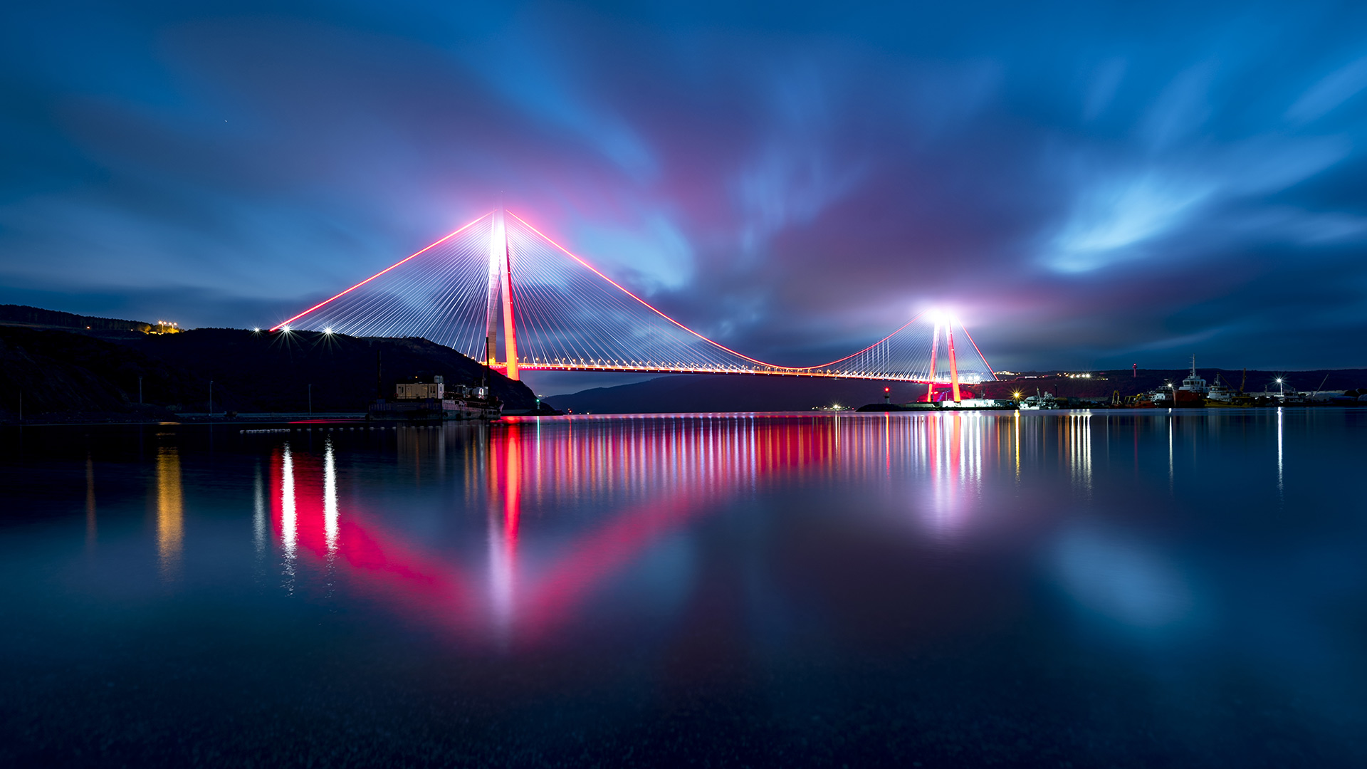 lighted bridge over water at night time