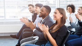 students clapping in meeting
