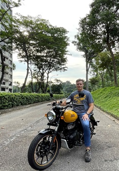 Alistair Dunstan posing beside his motorcycle