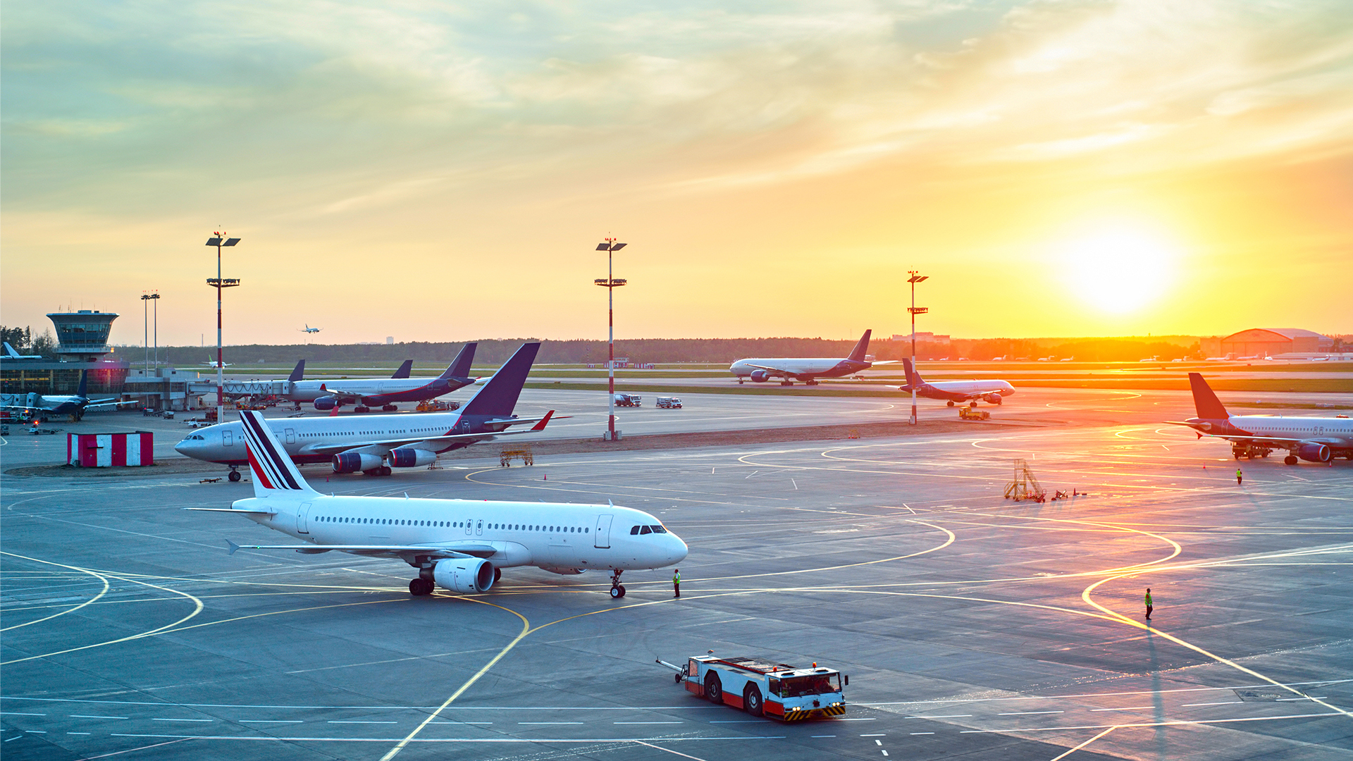 Airport with many airplanes at beautiful sunset