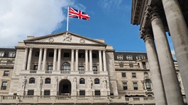 front of a bank with a British flag above it