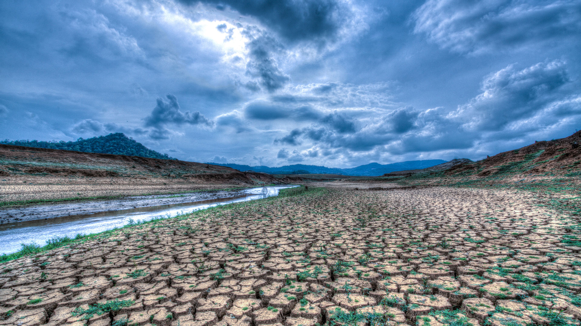 Dry cracked earth and mountains