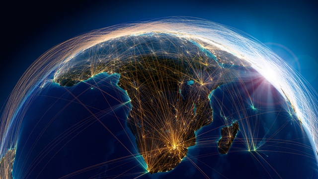 /Planet Earth with detailed relief is covered with a complex luminous network of air routes