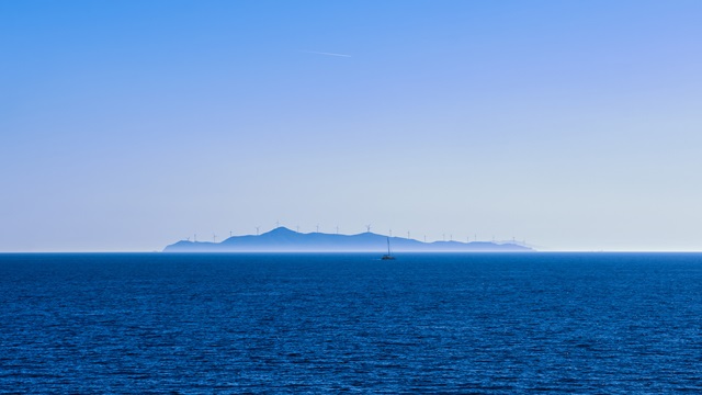 Seascape of calm azure sea and blue sky no clouds