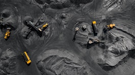 Industrial vehicles and workers at excavation site