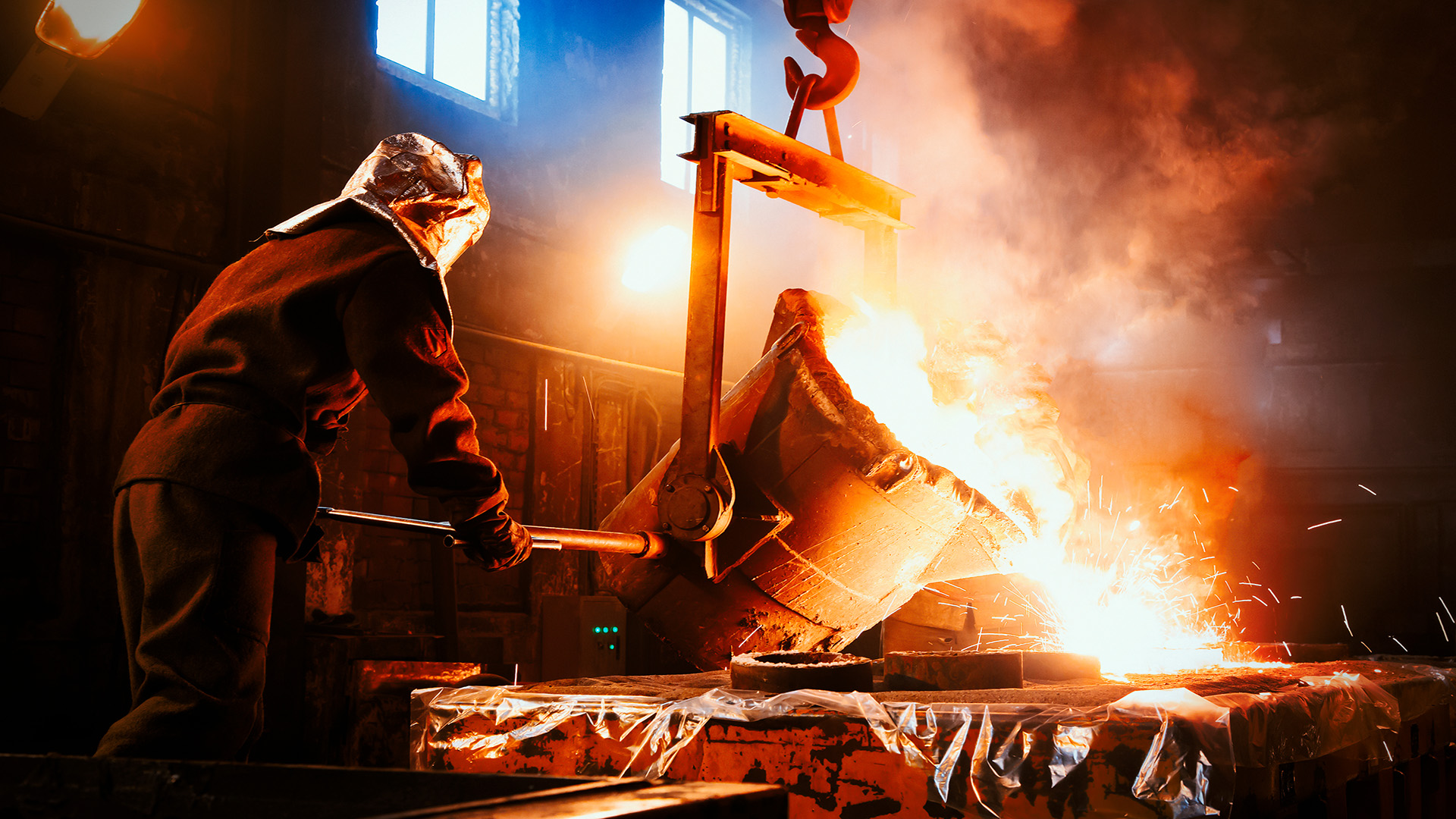 man-pouring-hot-iron-to-mold