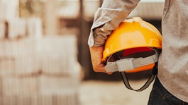 Person holding hard hat