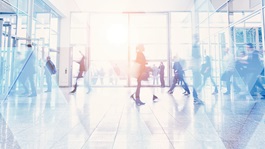 Pixelated employees in corporate office hallway