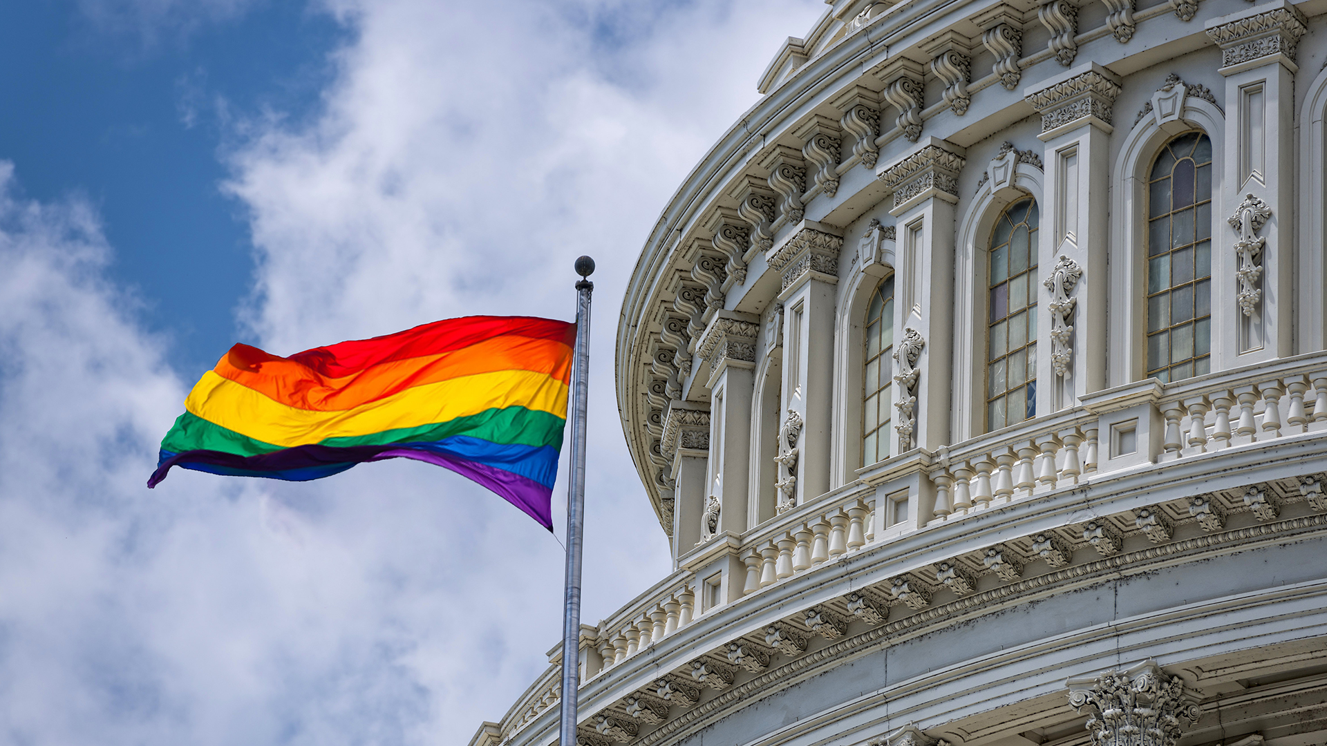 Pride flag flying next to US Capitol building