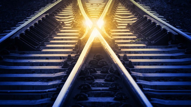 Crossing train tracks at sunset