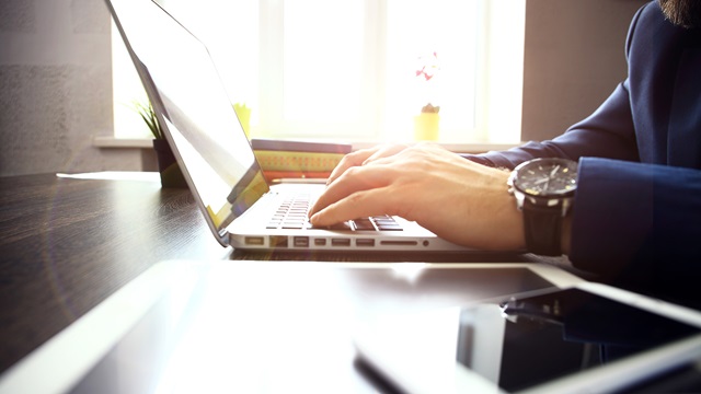 Typing on laptop