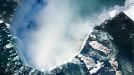 An aerial shot of the Canadian section of Niagara Falls, also known as Horseshoe Falls, with snow still present in early spring.