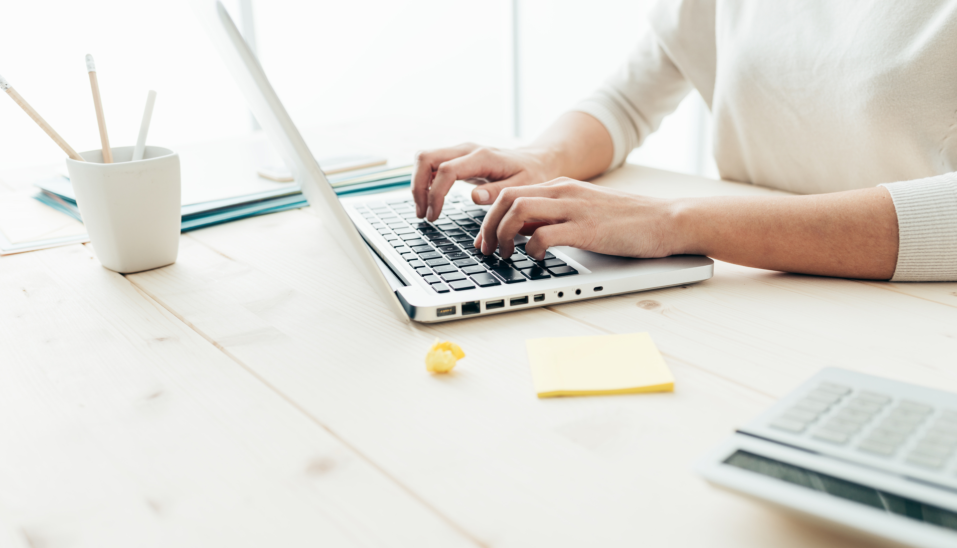 Women typing on a laptop