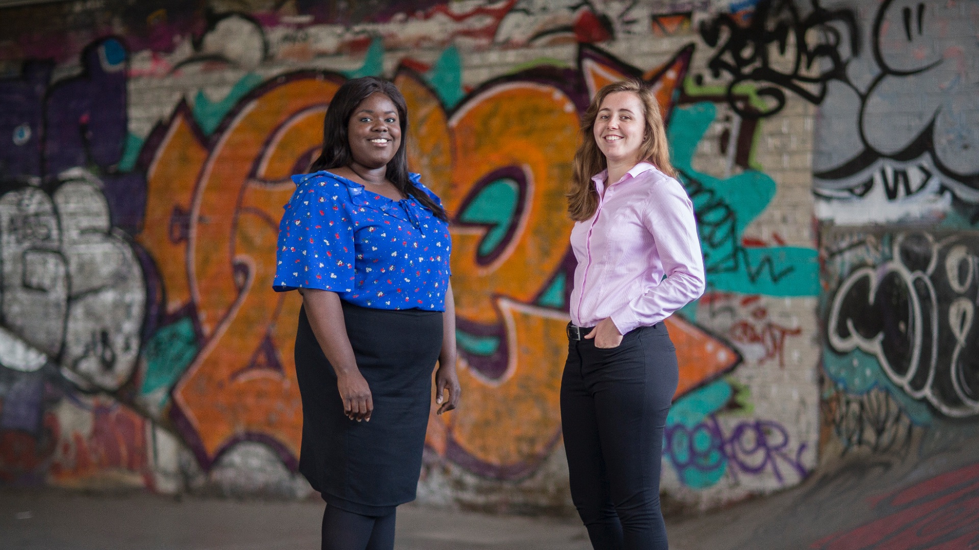 women with graffiti wall background