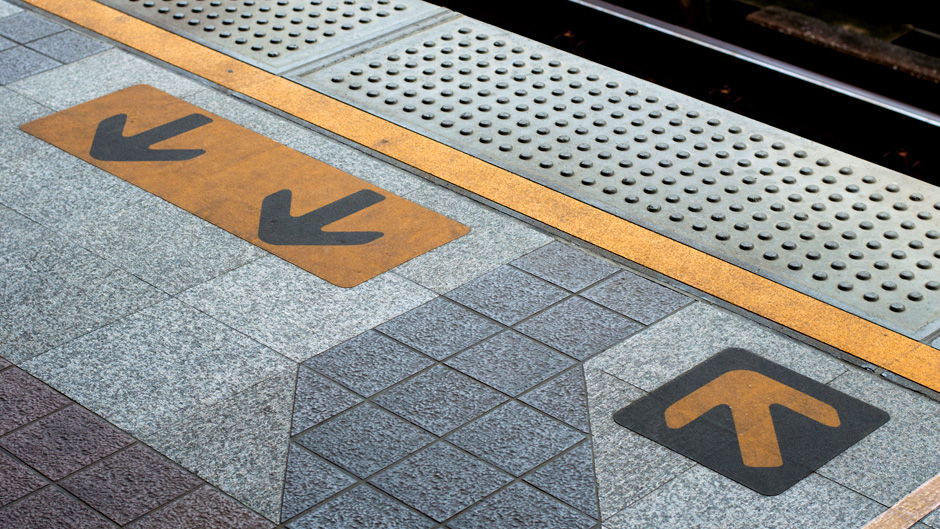 Sidewalk at subway station with arrows