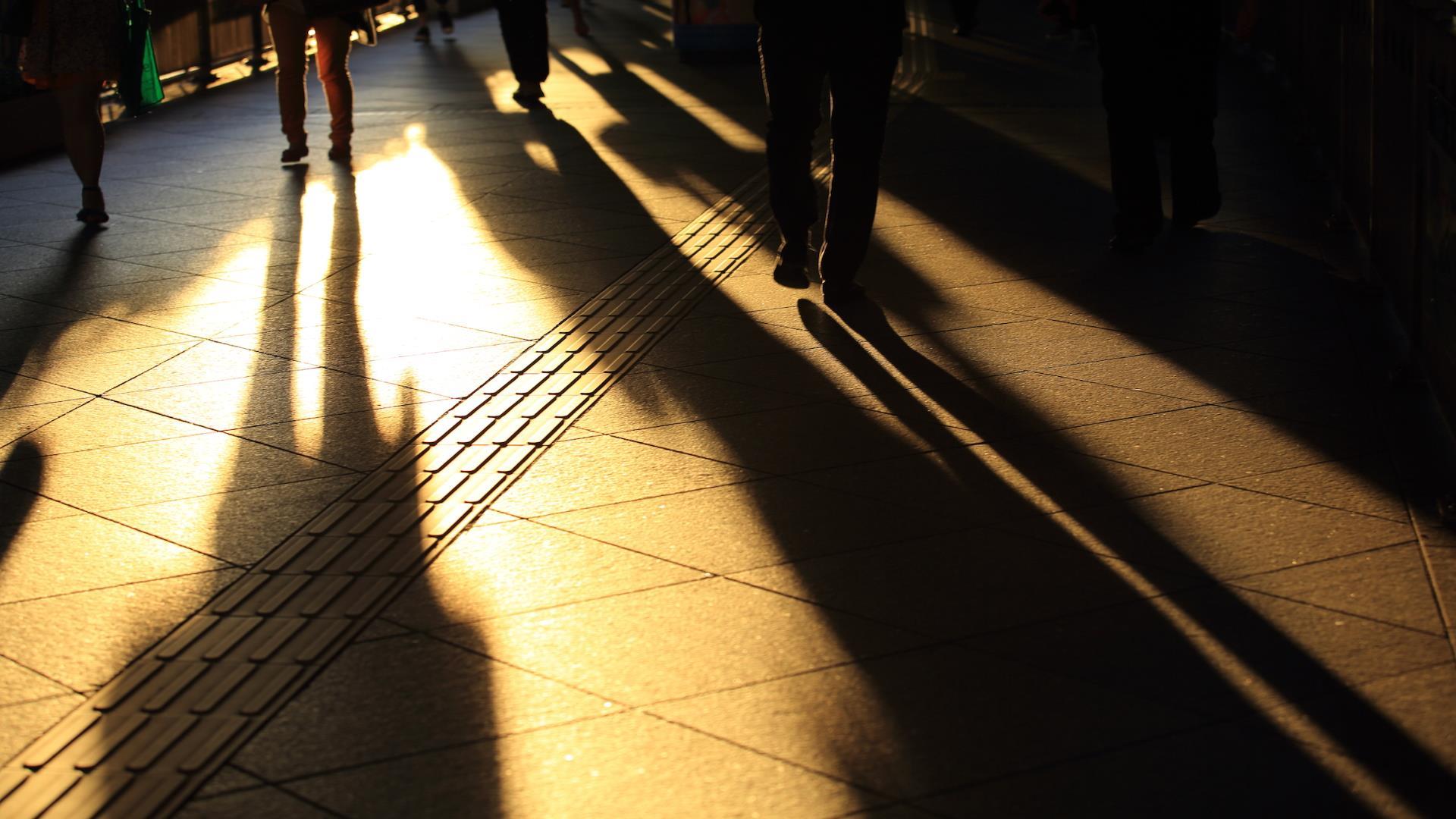 940x529_Employment People walking in shadow