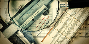 slide ruler magnifying glass statistics charts