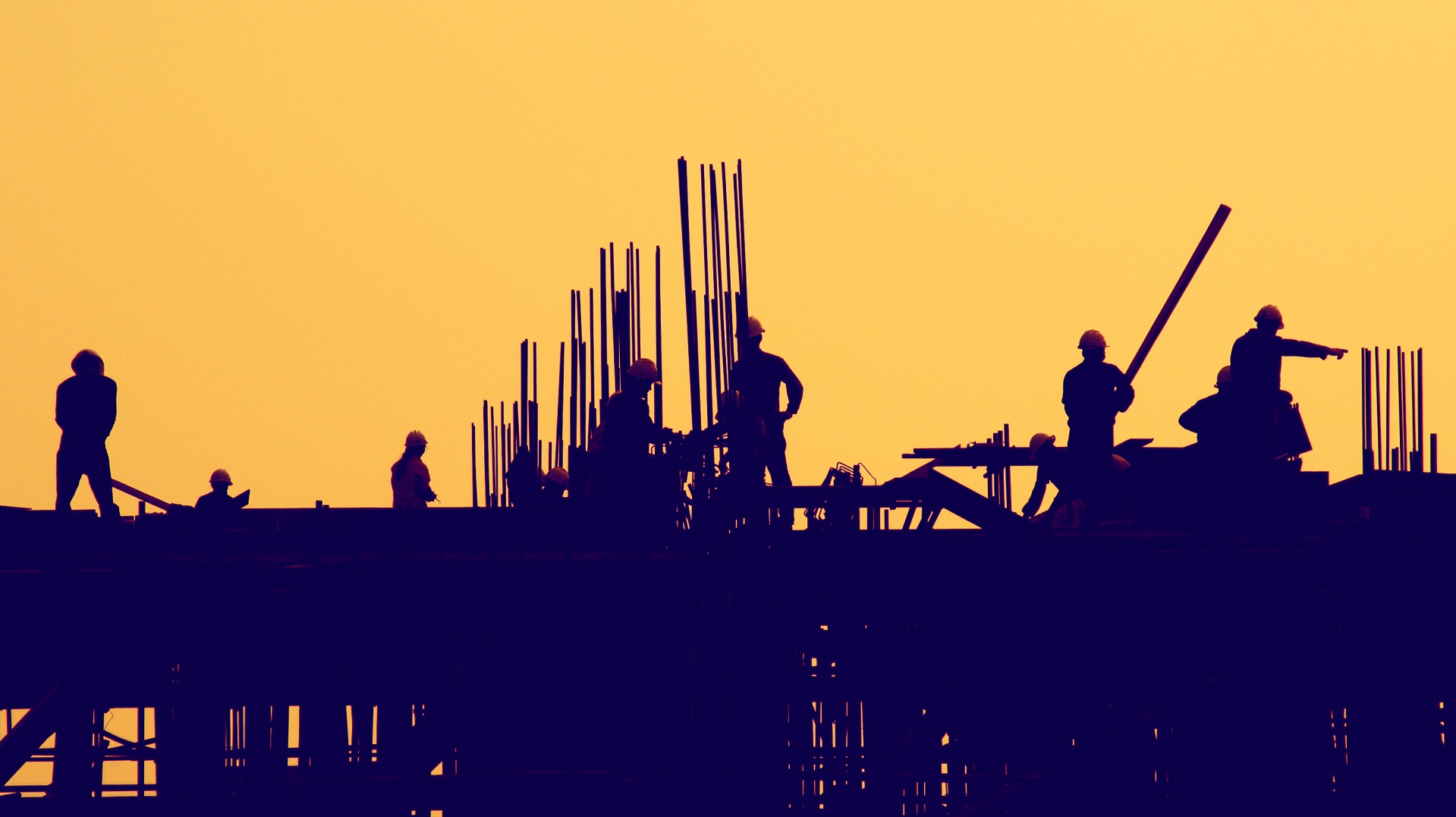 construction workers at sunset