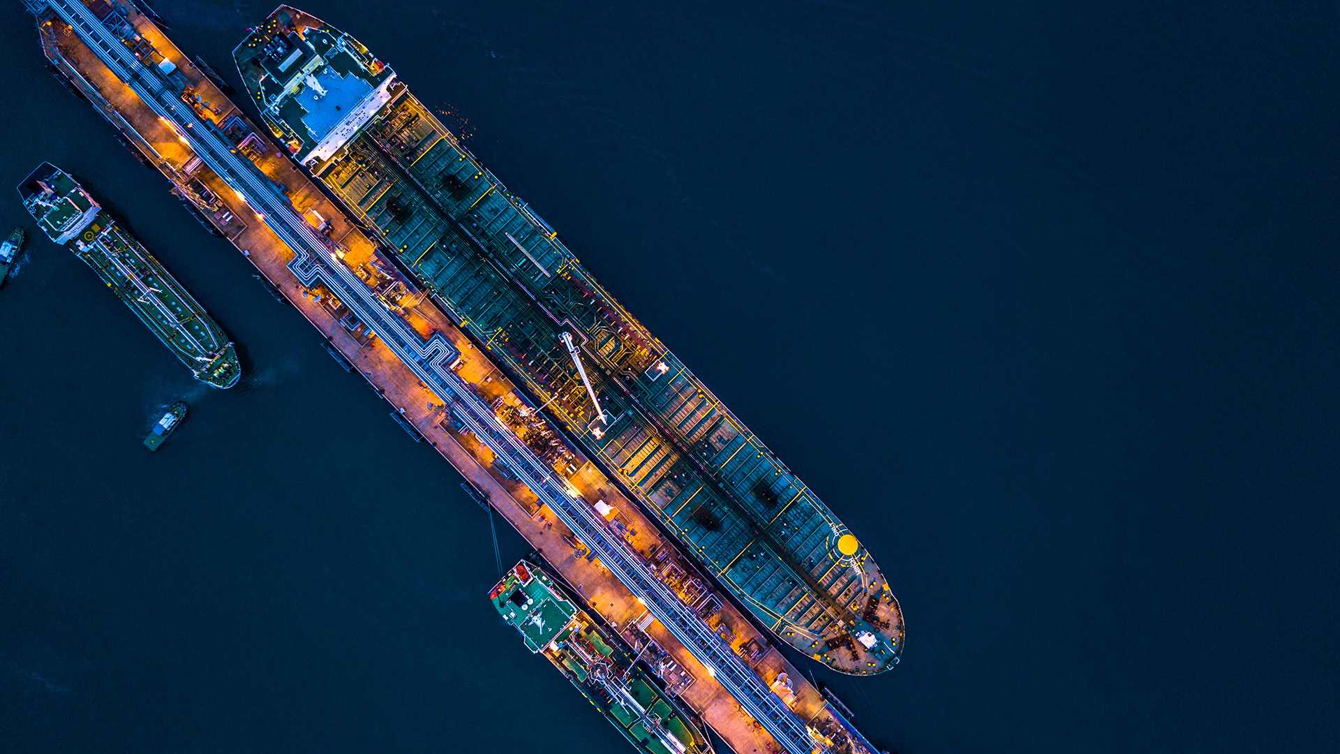 Image of cargo ships at dock at night