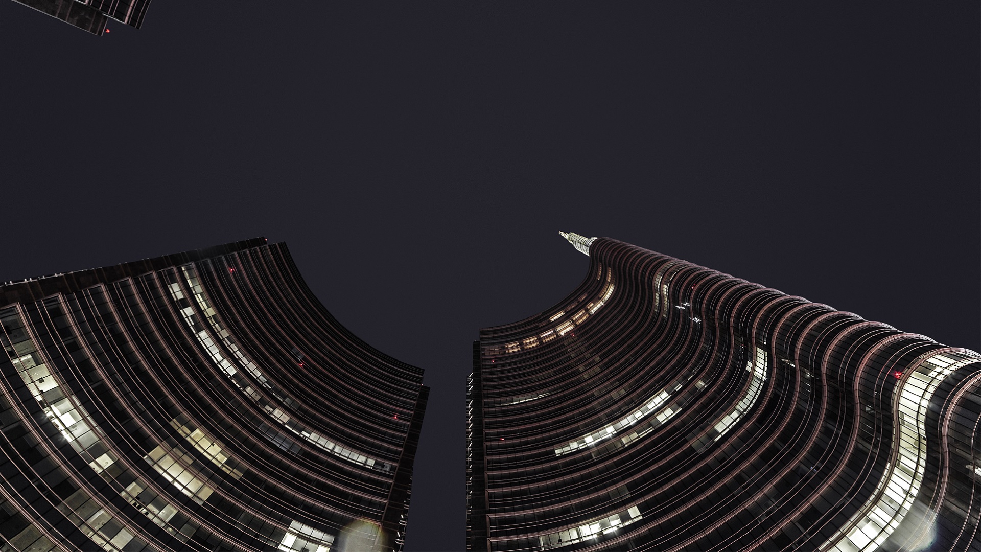 skyscraper looking up at the night sky