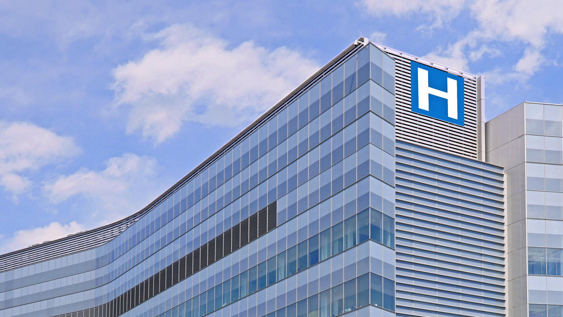 Hospital building with a blue sky and clouds above