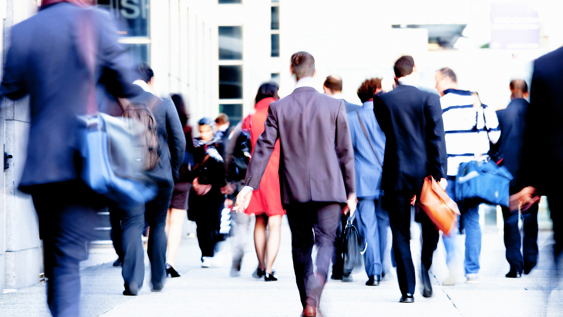 Commuters walking on sidewalk