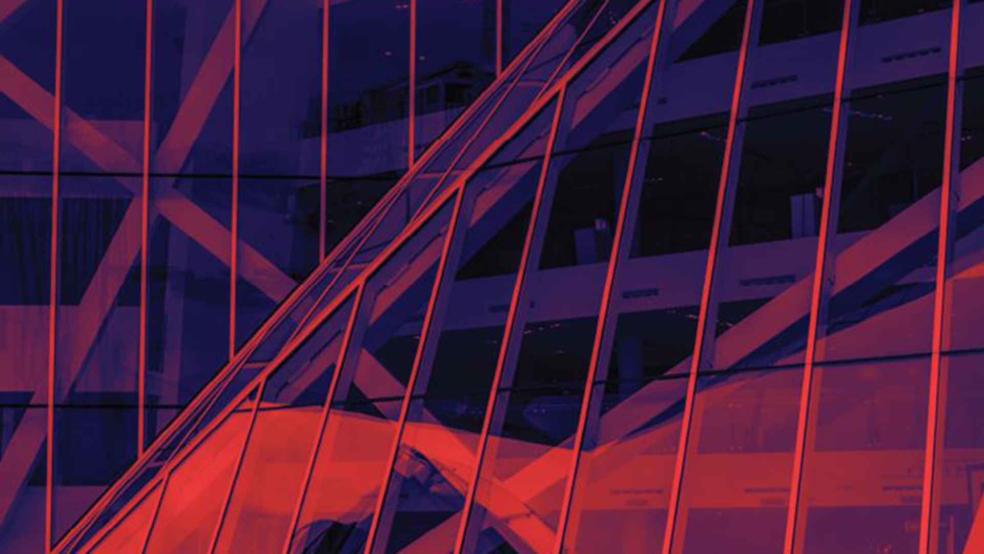 Red tinted image of office building with glass paneling
