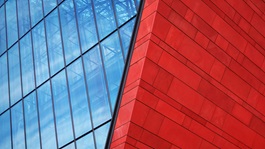 Financial-Restructuring-modern-glass-and-red-brick-building-with-blue-sky-background-metal-structure-glass-business-center