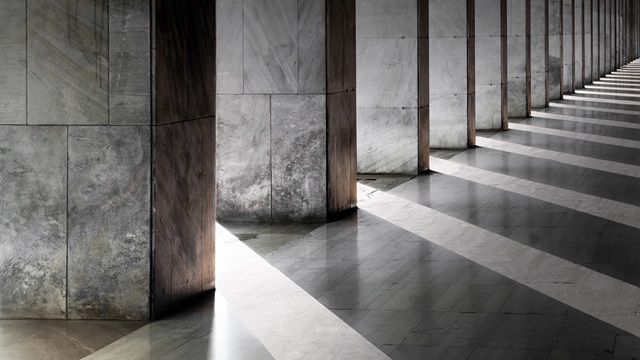 Gray marble hallway with column shadows