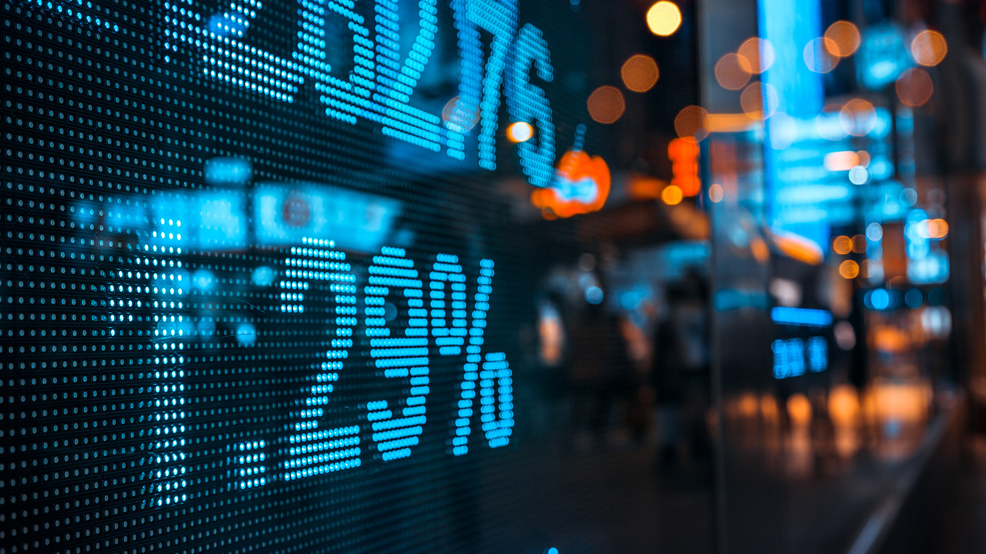 Image of shares on a screen, seen through a window