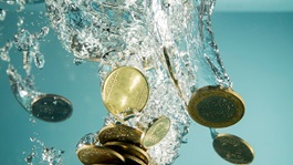 Coins splash in water