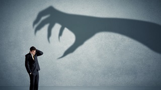 director businessman with scary shadow hand