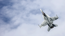 Jet flying through blue sky