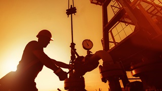 Oil worker checking the oil pump