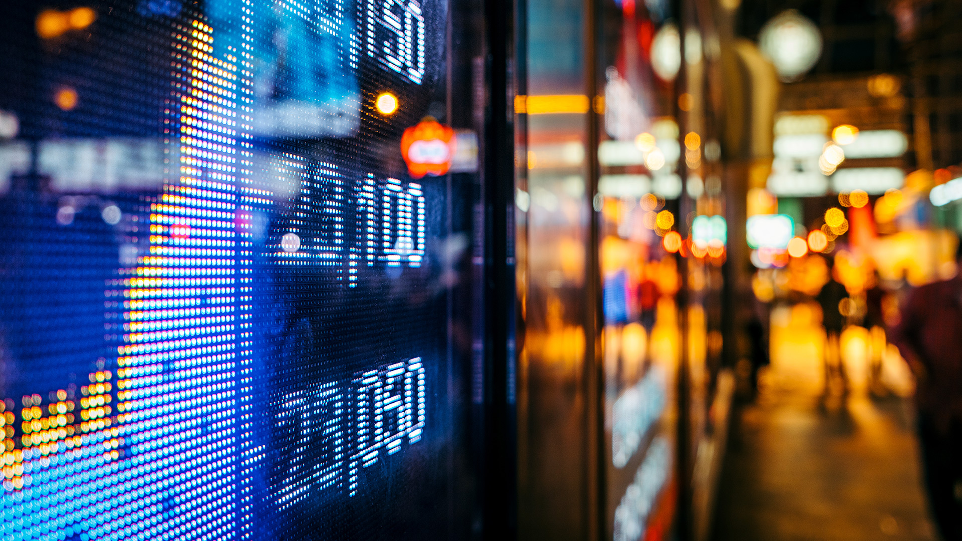 Blurred stock numbers, people in background