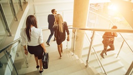 Two businesswomen walking down stairs