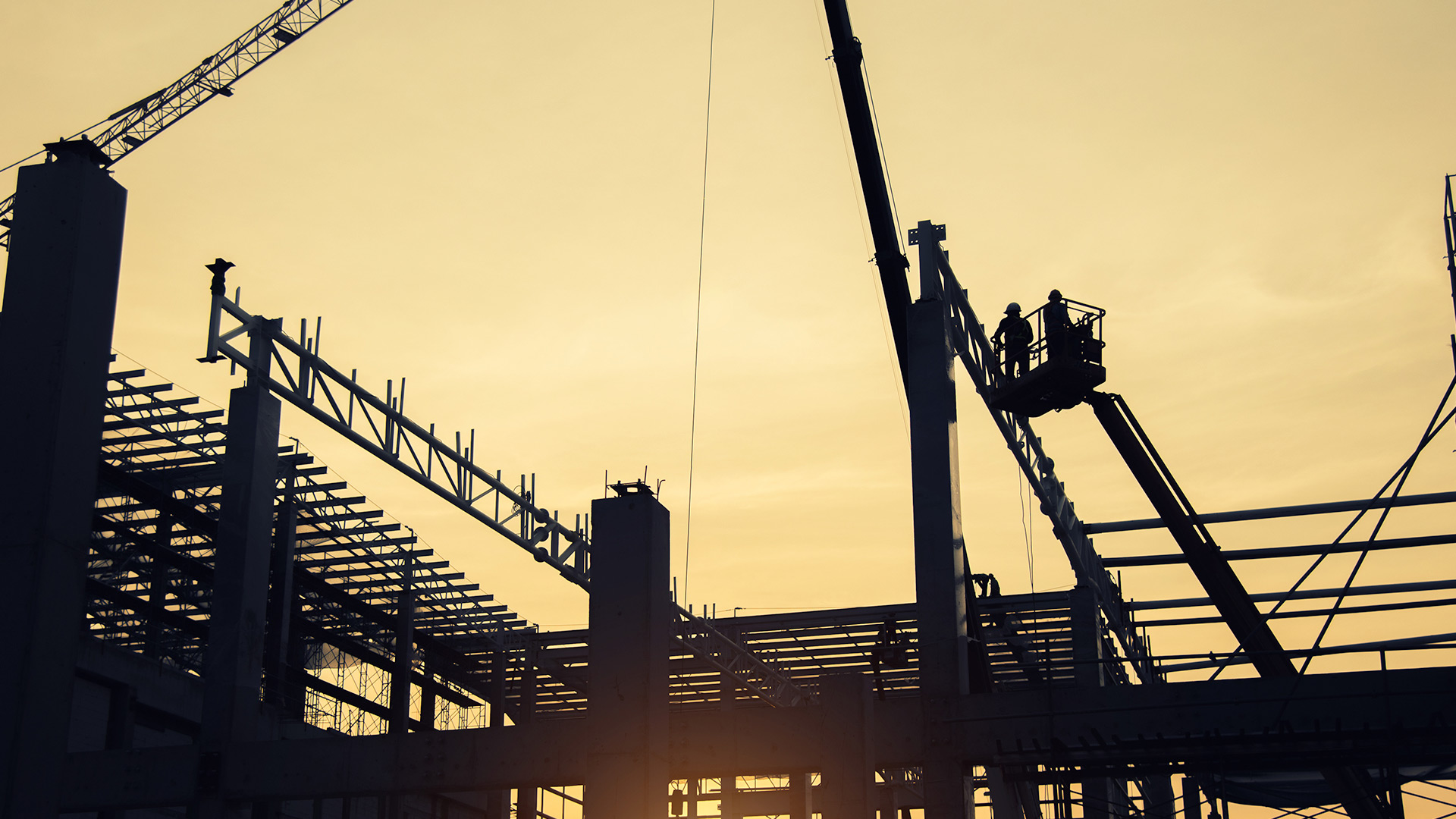 Silhouette of a crane and scaffolding on a construction site