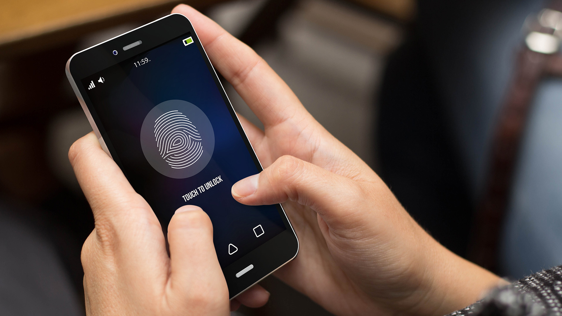 Cellphone in hands with fingerprint ID lock screen