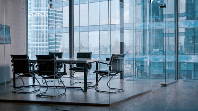 empty boardroom with chairs around a table