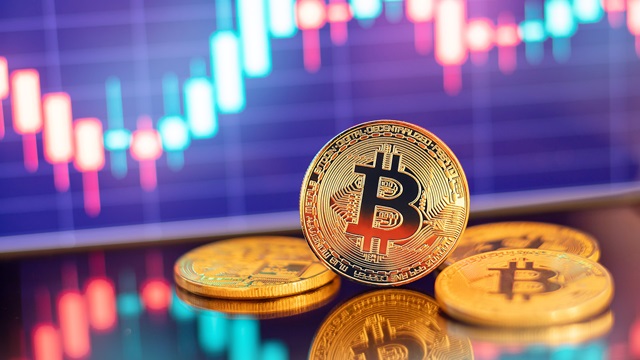 Digital tokens in a stack in front of a financial chart